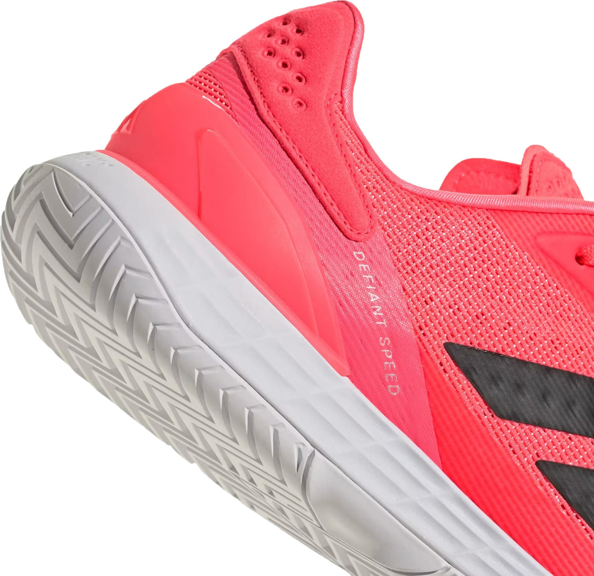 Close-up of the heel and sole of a bright coral adidas Defiant Speed 2 Mens Tennis Shoes - Solar Turbo / Core Black / Cloud White, featuring a textured white Ubersonic outsole and a black logo on the side.