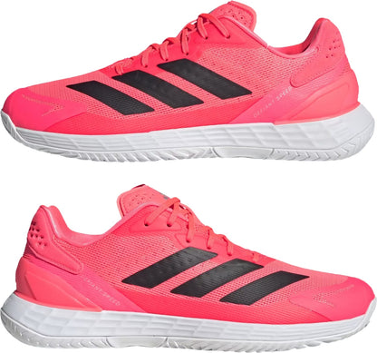 Side view of solar turbo, core black, and cloud white adidas Defiant Speed 2 Mens Tennis Shoes featuring bright pink coloring, three black stripes on the side, and white midsoles.