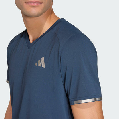 A person wearing the adidas Climacool+ Freelift Pro Mens Tennis T-Shirt - Aurora Ink, partially turned to the side against a plain background.