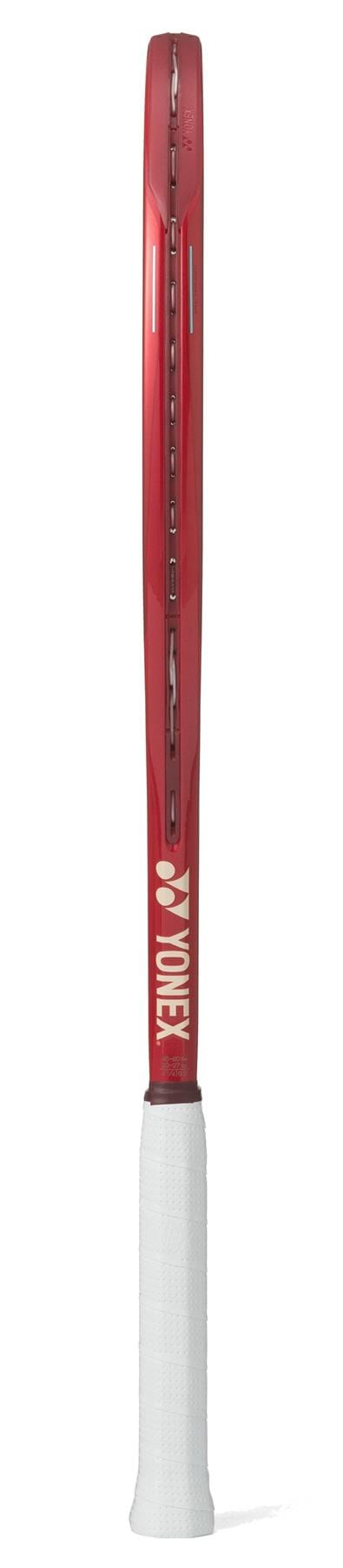 A Yonex VCORE 100 Ruby Red 2026 tennis racket shown from the side, featuring a white grip and Yonex branding on the throat—designed for players seeking maximum spin.