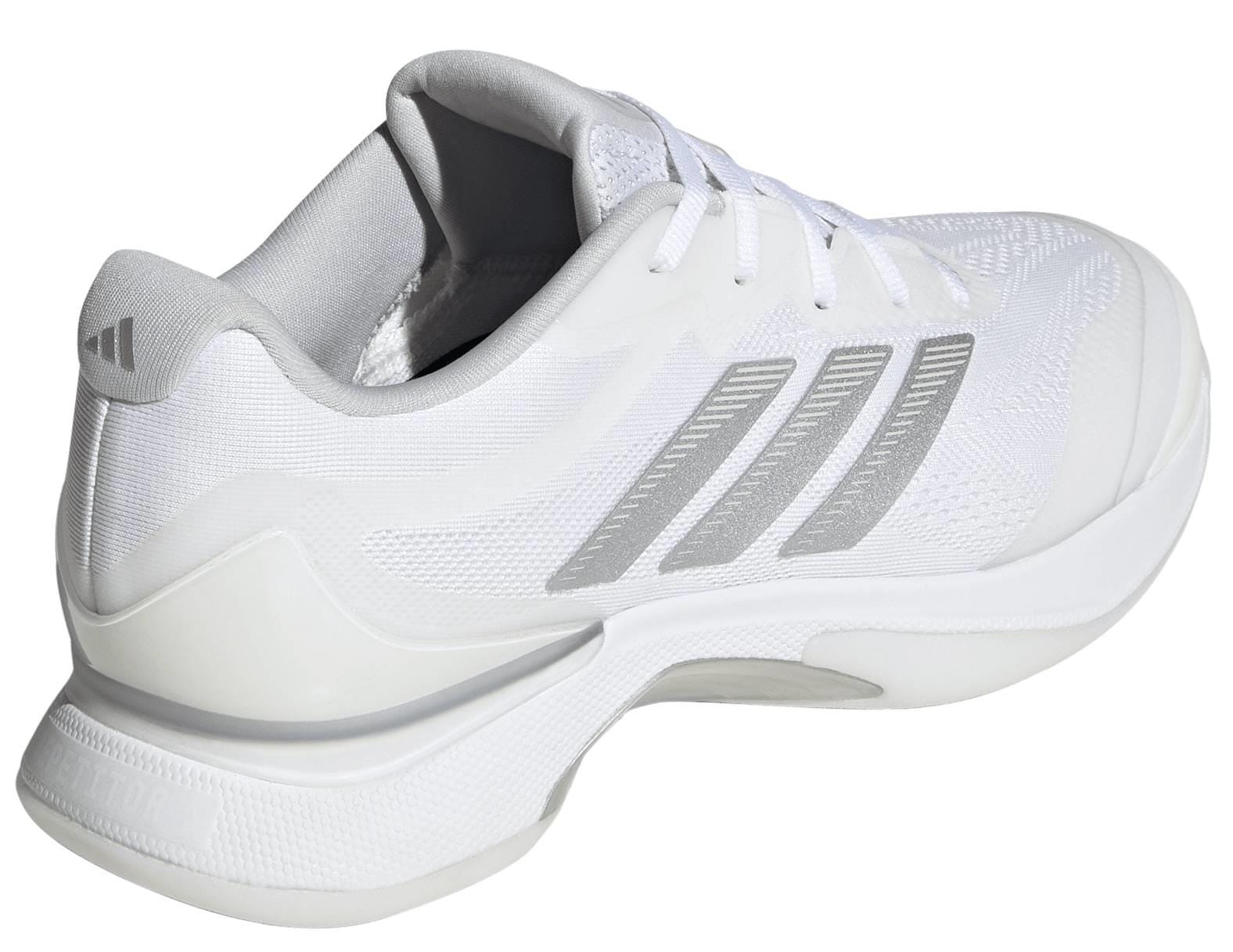 The adidas ADIDAS Avacourt 3 Womens Tennis Shoes in white feature light gray stripes, white laces, and a thick sole—ideal for stylish women seeking performance tennis shoes. Shown from an angled rear side view.