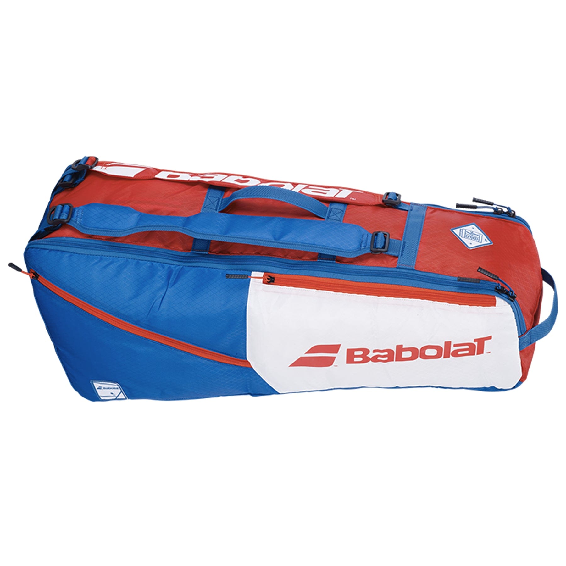 Introducing the Babolat RH6 Evo Drive Tennis Bag in a striking white, blue, and red color scheme. This spacious bag accommodates up to 6 rackets and includes several zippered compartments for organization. It is designed with both top and side handles, as well as detachable shoulder straps for convenient carrying options, all while proudly showcasing the Babolat logo.