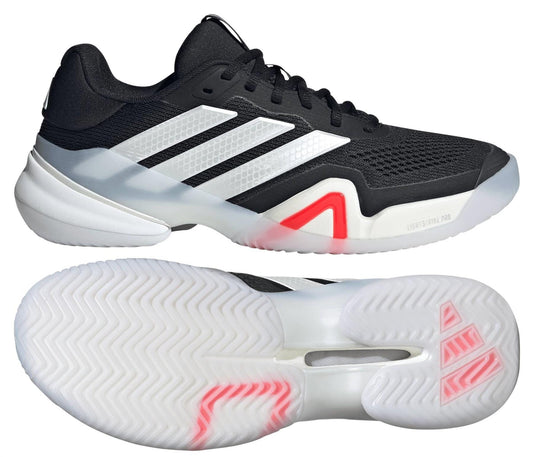 The adidas Barricade 14 Men's Tennis Shoes in black feature white accents, three white stripes, a translucent zigzag tread sole, and a red midsole detail—ideal for tennis courts.