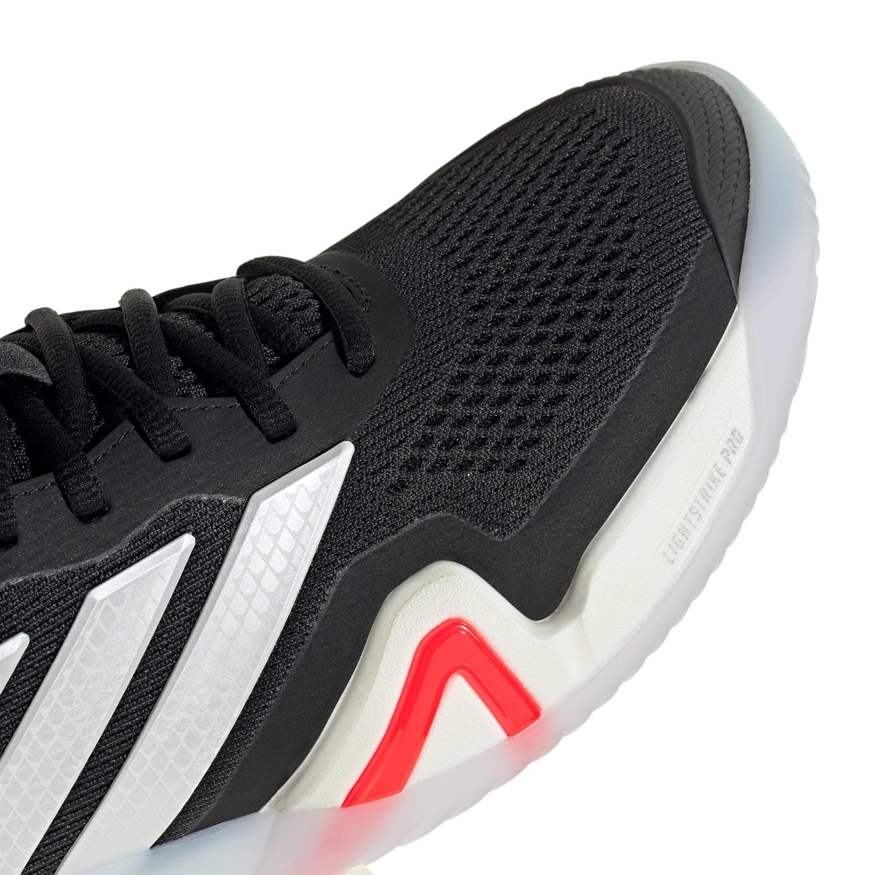 Close-up of the adidas ADIDAS Barricade 14 Men's Tennis Shoe in black, featuring a mesh upper, white and silver side stripes, a white sole with a translucent edge, and a red accent at the midsole.
