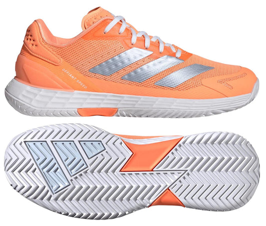 The ADIDAS Defiant Speed 2 Womens Tennis Shoes in orange by adidas are shown from the side and sole, featuring silver stripes, a white midsole, and a patterned rubber outsole. Lightweight design offers comfort and speed for women on the court.