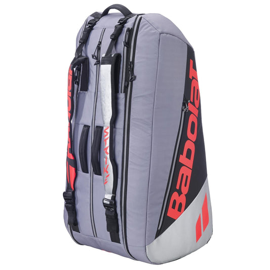 The Babolat RH9 Pure Strike 9 Racket Tennis Bag in Carbon Grey features multiple zippered compartments, shoulder straps, and a sturdy handle. Water-repellent, it keeps your gear protected on the go.