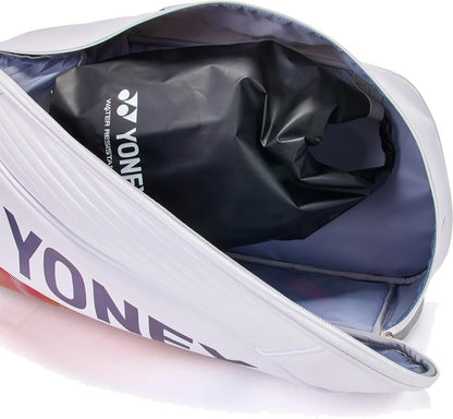 A Yonex 02626EX Expert 6 Racket Tennis Bag - White, partially unzipped, shows a black water-resistant Yonex pouch inside the light gray main compartment designed for racket storage.
