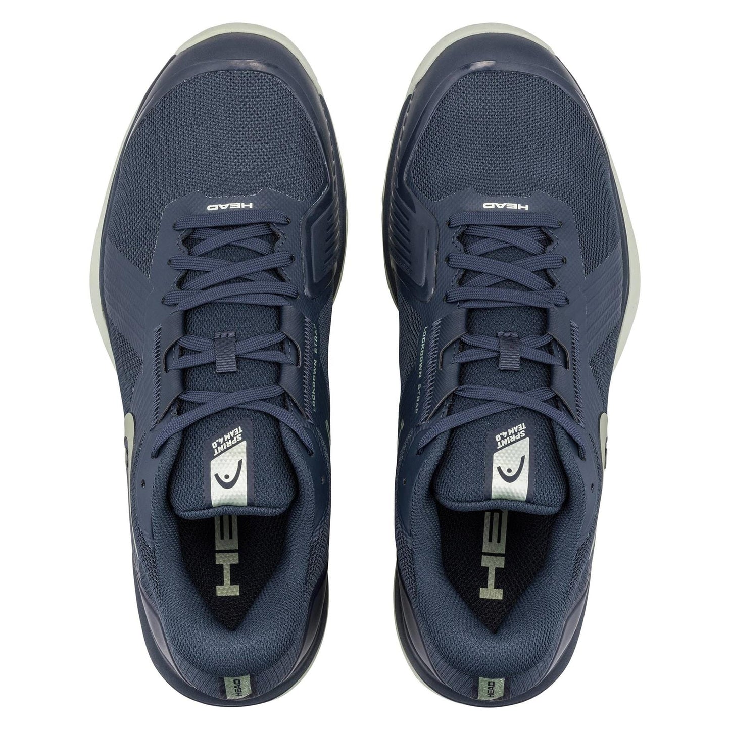A pair of HEAD Sprint Team 4.0 Men's Tennis Shoes in navy and cantaloupe green, viewed from above, showing the HEAD logo on the tongues and insoles along with breathable design elements.