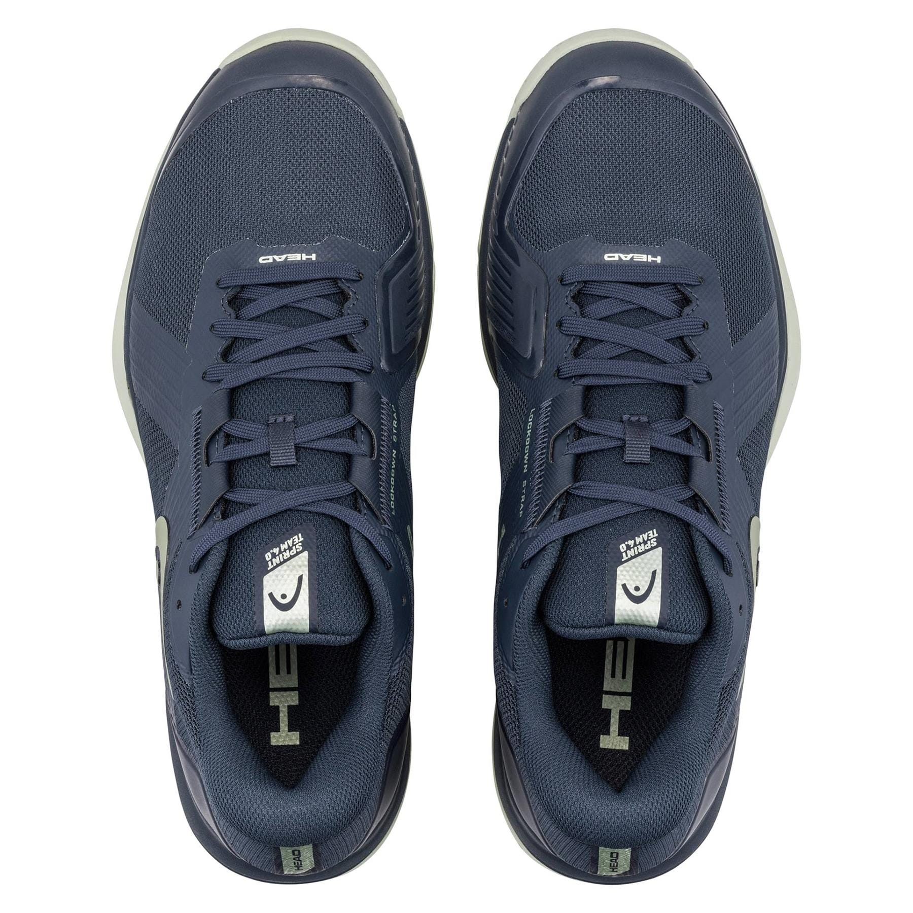A pair of HEAD Sprint Team 4.0 Men's Tennis Shoes in navy and cantaloupe green, viewed from above, showing the HEAD logo on the tongues and insoles along with breathable design elements.