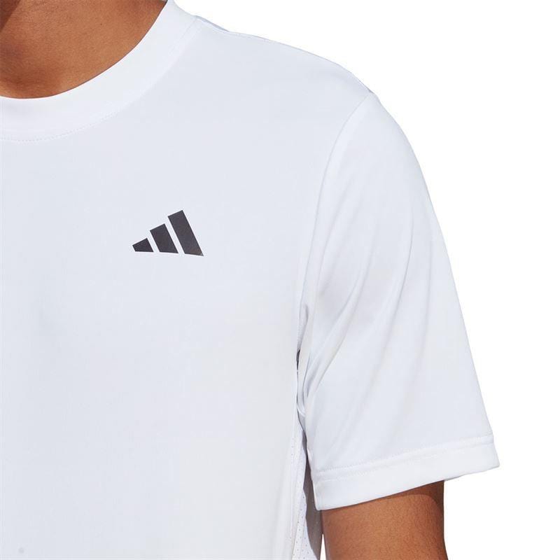 A person wearing the ADIDAS Men's Club Tennis T-Shirt in white with a small, three-stripe logo on the upper left side is shown. The image focuses on the upper body, emphasizing the AEROREADY fabric while cropping out the face.