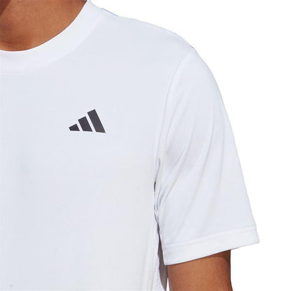 A person wearing the ADIDAS Men's Club Tennis T-Shirt in white with a small, three-stripe logo on the upper left side is shown. The image focuses on the upper body, emphasizing the AEROREADY fabric while cropping out the face.