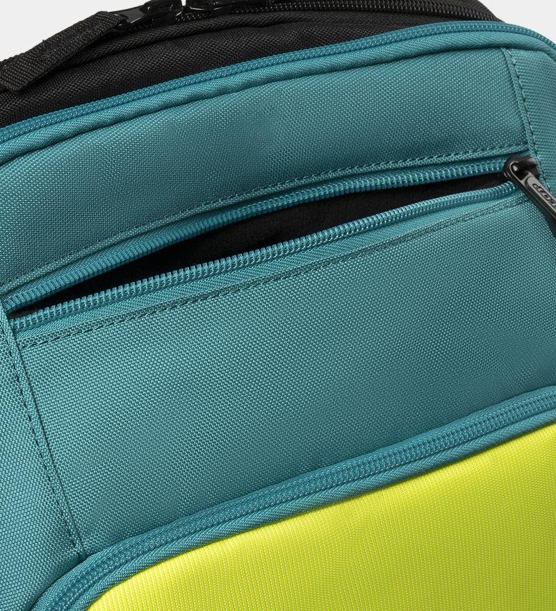 Close-up of a Dunlop SX Performance Tennis Backpack featuring teal fabric and a visible zippered pocket. The contrasting black and yellow sections, ideal for carrying rackets, highlight the detailed stitching and texture.