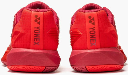 A close-up rear view of two Yonex Power Cushion Eclipsion 5 Womens Tennis Shoes in ruby red, side by side, highlights the Yonex logo and brand name vertically on each heel.