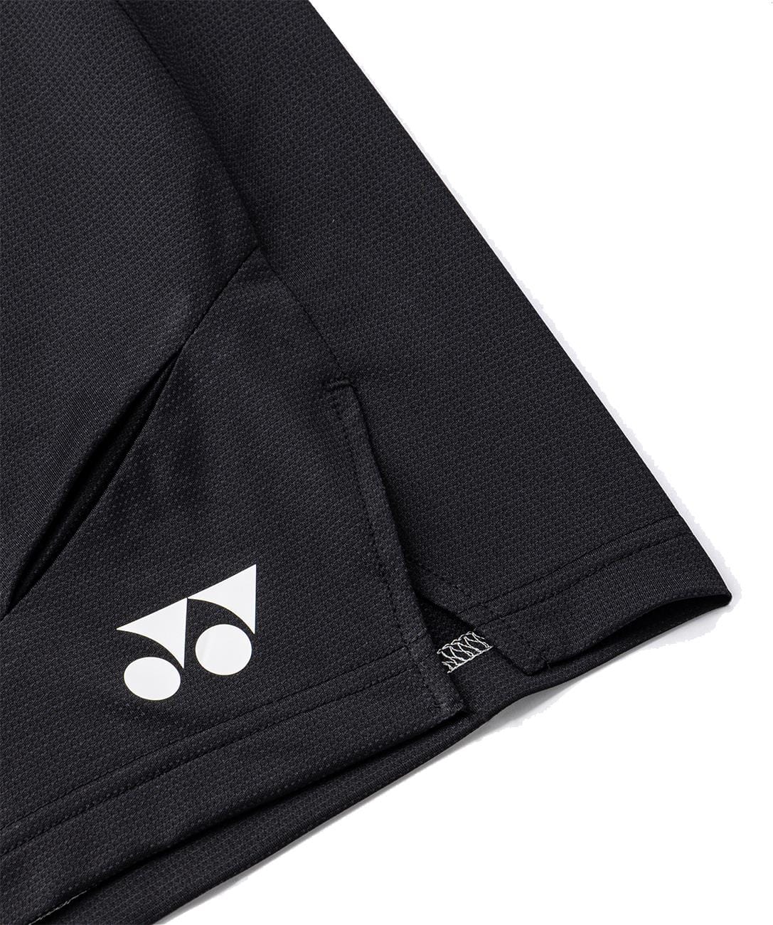Close-up of Yonex 15239YX Knit Men's Tennis Shorts in black, featuring a breathable textured fabric and a pocket with the white Yonex logo near the seam—designed for performance on the court.