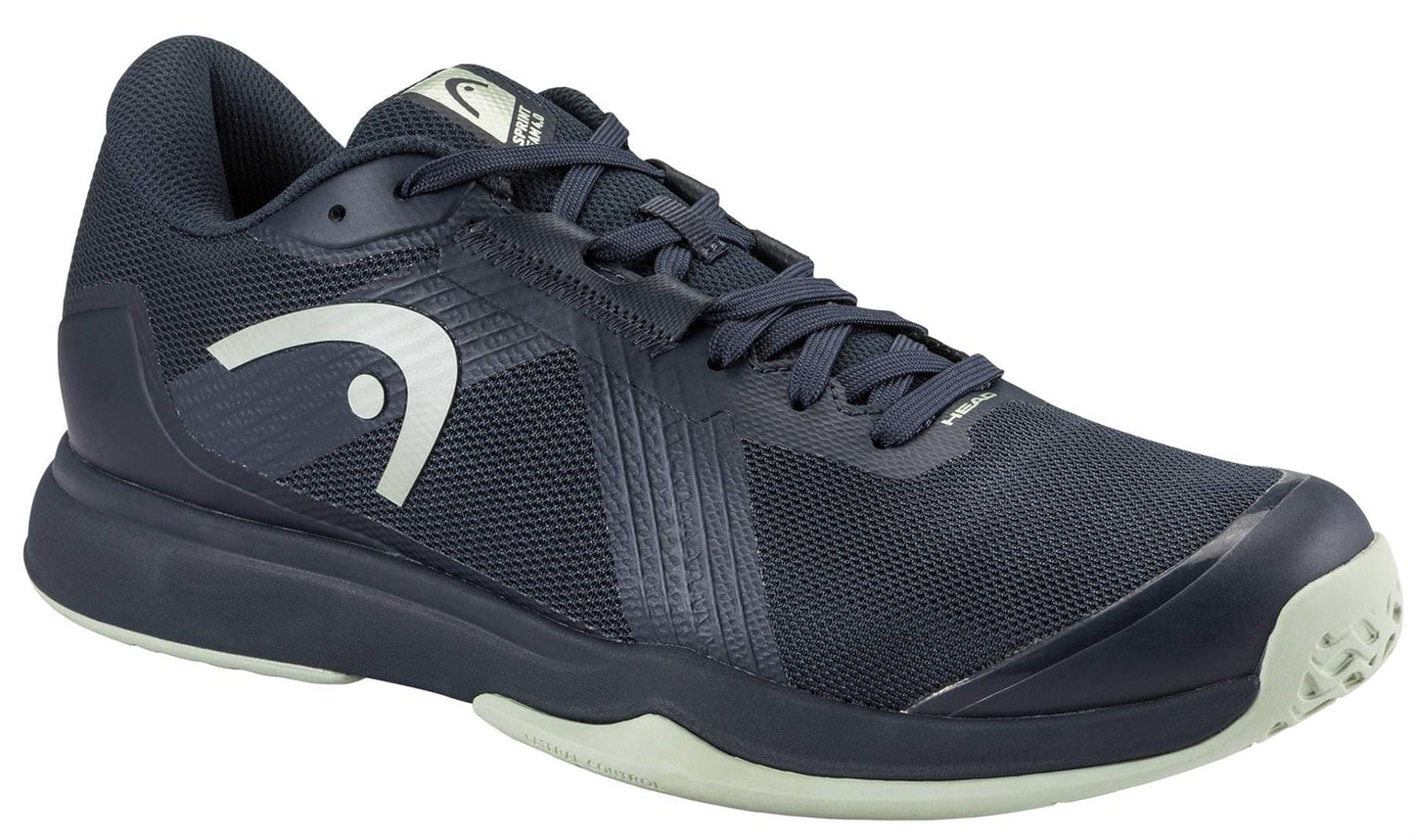 The HEAD Sprint Team 4.0 Men's Tennis Shoes in Navy/Cantaloupe Green feature a breathable textured mesh upper, a white HEAD logo on the side, and a light sole—perfect for both sports and casual wear.