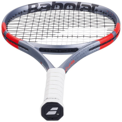 A Babolat Pure Strike Lite Gen4 Tennis Racket in Carbon Grey, featuring a lightweight frame with black strings and a white grip, is pictured from a low angle focusing on the handle and lower racket head.