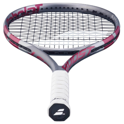 A close-up of the Babolat Boost Aero Pink 2026 Tennis Racket shows a white grip, black strings, and a gray and pink frame—ideal for entry-level players. The Babolat logo appears on the handle end.