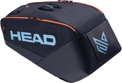 The HEAD Pro 9 Racket Tennis Bag L - Navy by HEAD features orange zippers, a large light blue "HEAD" logo, an abstract symbol, a top handle, and a sleek angular design inspired by the Jannik Sinner tennis bag.