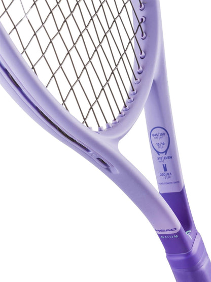 Close-up of a HEAD Boom Jr 25 Alternate 2026 Junior Tennis Racket in purple, showing the strings and frame. Technical specs and Hy-Bor technology are printed on the inner side near the handle of this HEAD junior tennis racket.