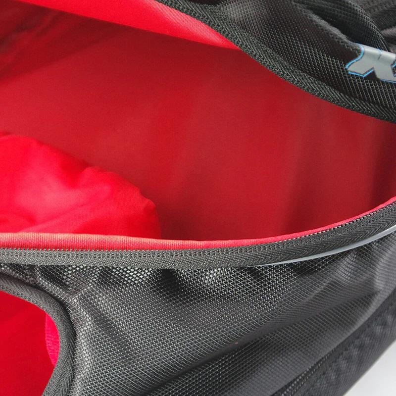 Close-up of the Karakal Pro Tour 30 2.1 Tennis Backpack, a black and blue backpack featuring a 30-litre capacity. The image showcases the partially open main compartment lined in red, emphasizing its durable texture and equipped with padded shoulder straps for enhanced comfort.