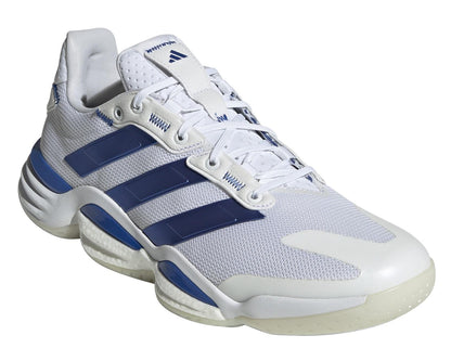 The adidas Stabil 16 Men's Indoor Court Shoes in white and blue feature a signature three-stripe design, a breathable mesh upper, lace-up closure, and a textured rubber sole for grip. These sustainable shoes provide both style and performance.