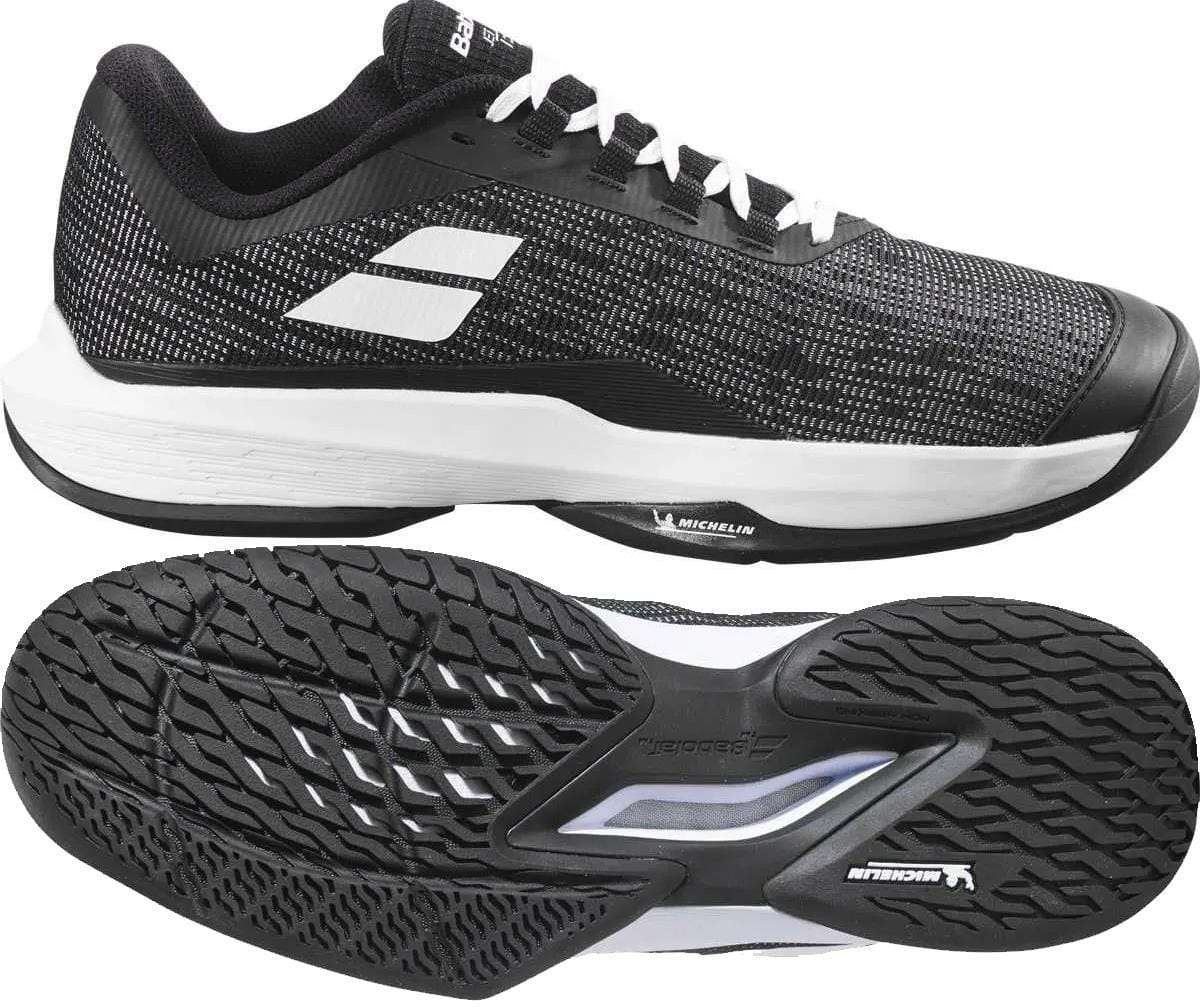 The Babolat Jet Tere 2 All Court Men's Tennis Shoes in Black/White are shown from the side and bottom, highlighting their ultra-lightweight design, textured sole with bold tread patterns, and white accents on the upper and sole.