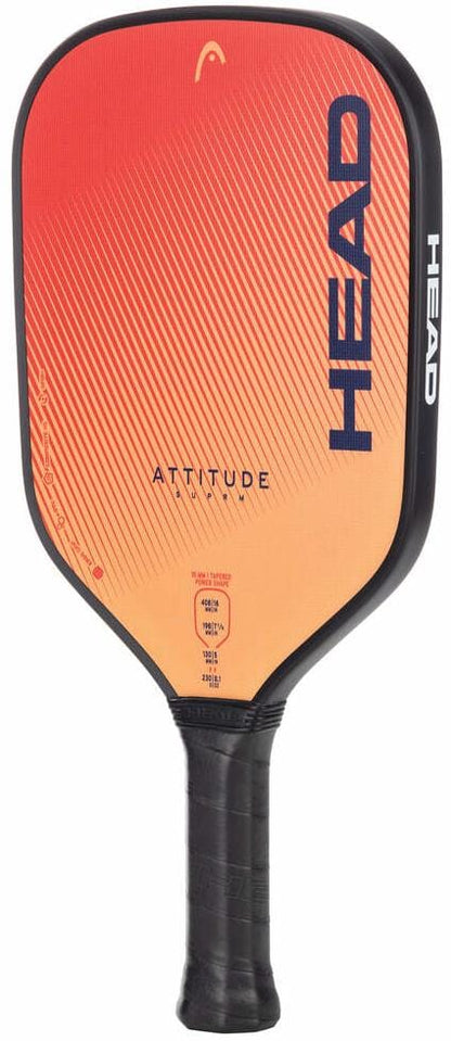 The HEAD Attitude SUPRM Pickleball Paddle features a gradient red-orange face, black edges and handle with grip tape, and large vertical blue “HEAD” branding—ideal for beginners seeking reliable spin control.