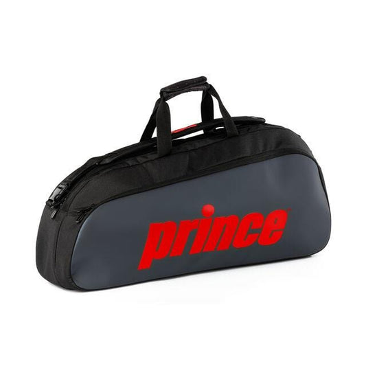 This stylish Prince Tour 1 Comp 3 Racket Tennis Bag, available in red, features an elongated design for transporting rackets and displays the "Prince" brand prominently. It includes a convenient top handle and an accessory pocket for additional practicality.
