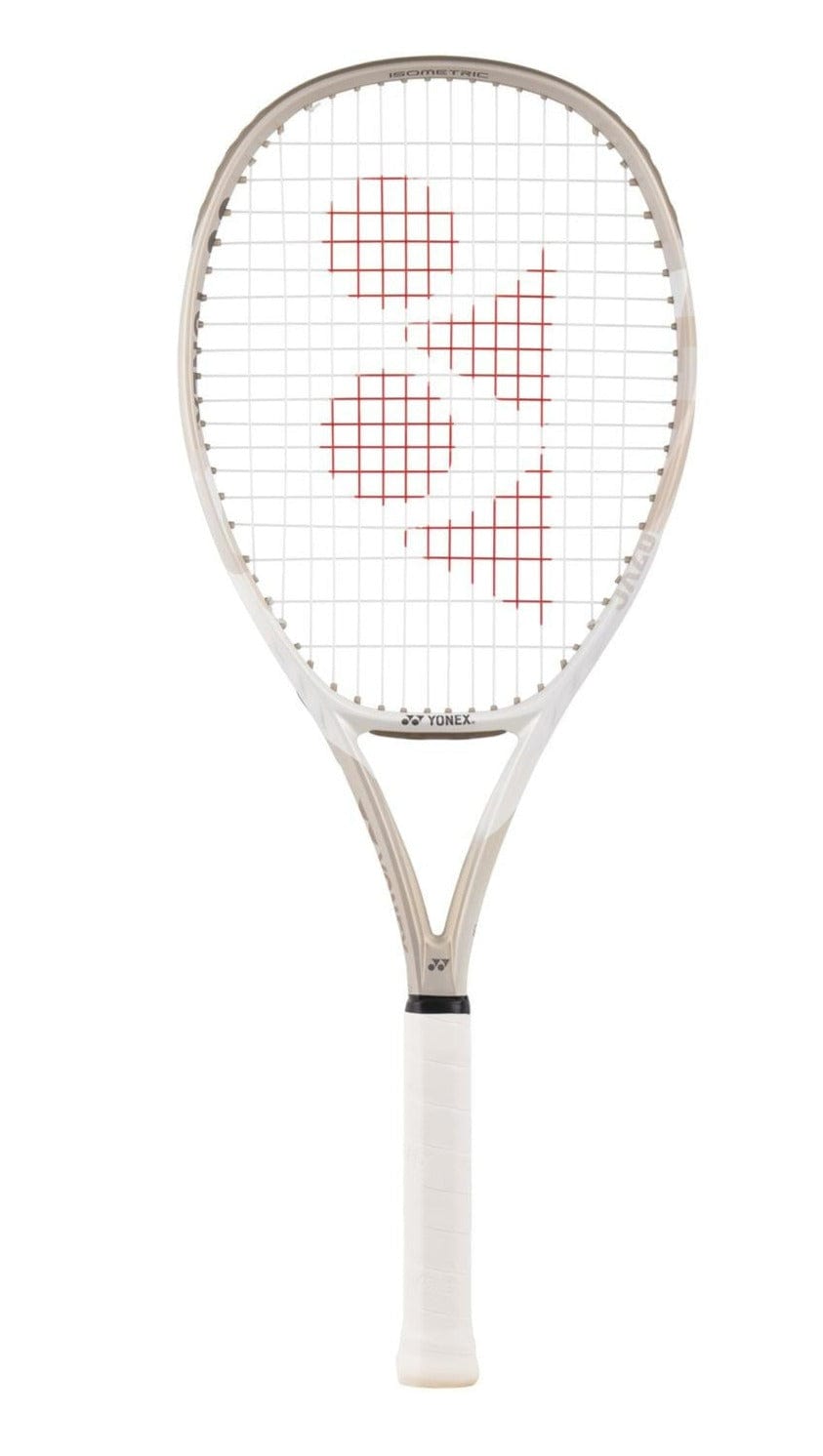 The Yonex VCORE Game Tennis Racket in sand beige features a lightweight frame and a slightly curved build. It embodies the innovative ISOMETRIC™ design, with a white grip tape handle. The white racket showcases red designs on the strings, along with the Yonex logo.