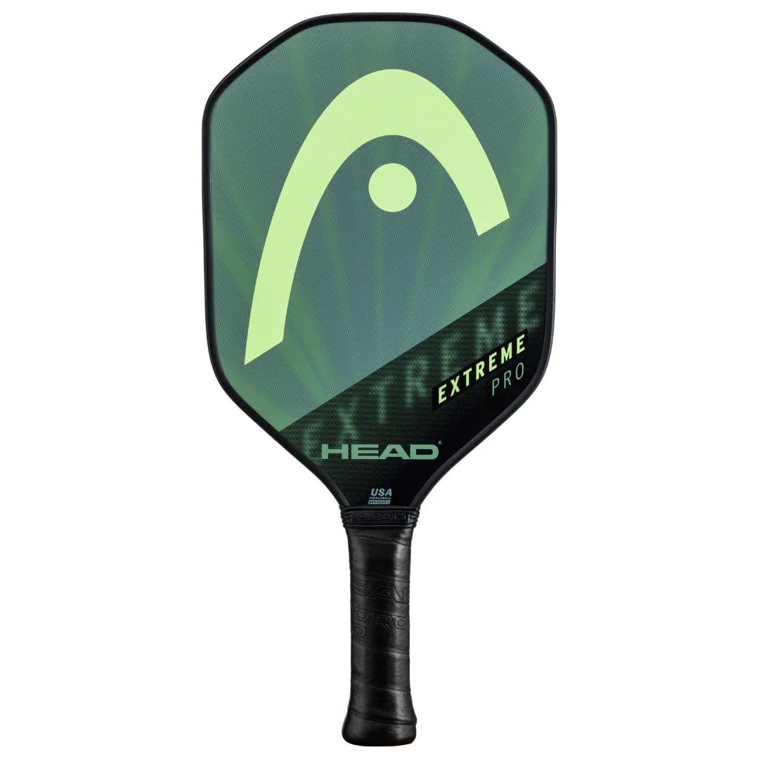 The HEAD Extreme Pro 2023 Pickleball Paddle in black and green features a large logo, black Comfort Grip handle, and a durable composite hitting surface.
