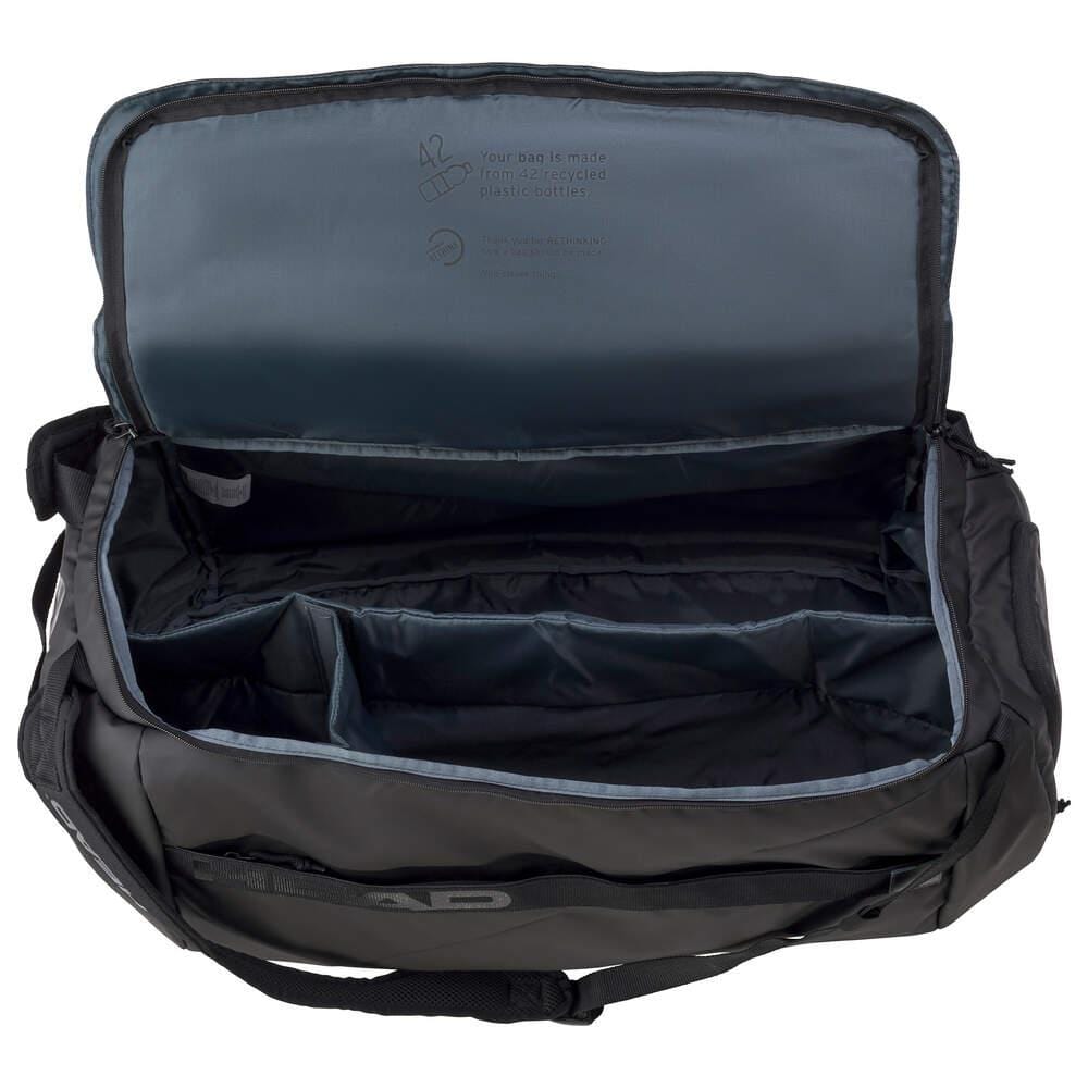The HEAD Pro X Tennis Duffle Bag L - Black by HEAD includes several compartments and a roomy, lined interior crafted from recycled PET bottles. Equipped with a zipper closure, shoulder strap, durable handles, and CCT+ climate control technology, this empty bag is ideal for any tennis enthusiast.
