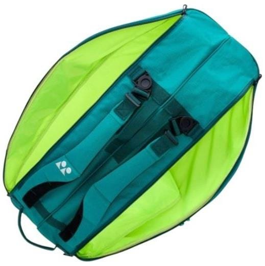 A Yonex 92426EX 6 Racket Pro Tennis Bag in dark green is shown lying flat with visible shoulder straps, back panel, and black strap buckles—a modern design ideal for storing your tennis gear.