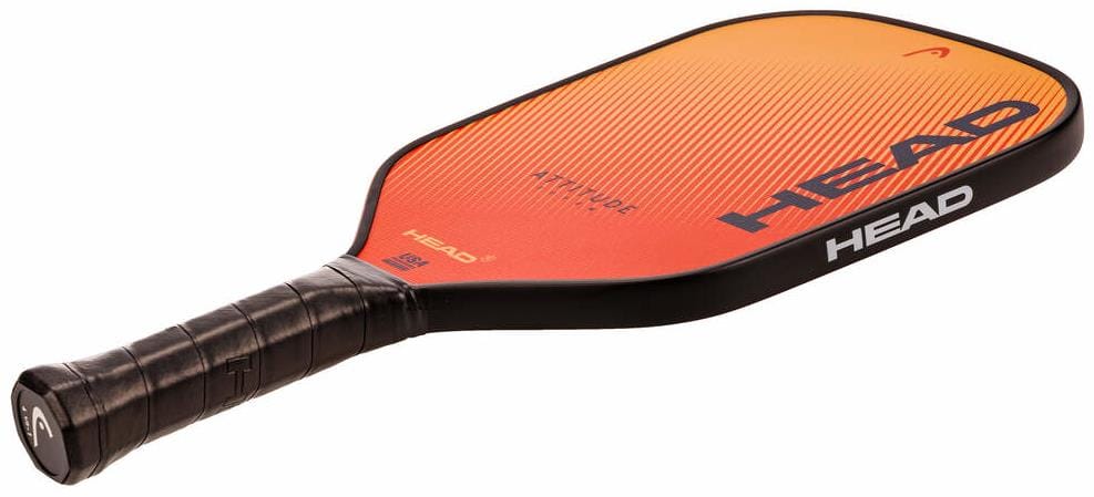 The HEAD Attitude SUPRM Pickleball Paddle has a black handle, an orange-to-red gradient face, "HEAD" branding, and "ATTITUDE" near the top. It offers excellent spin control—ideal for beginner players.