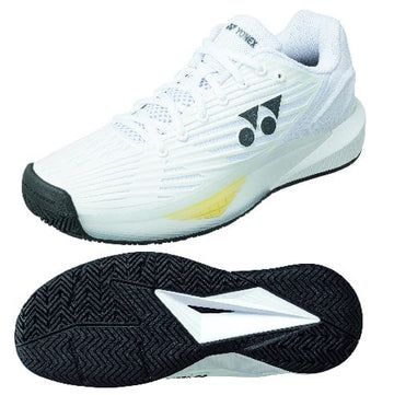 The Yonex Power Cushion Eclipsion 5 Men's Tennis Shoes in white, featuring stylish black accents and a yellow side highlight, showcase both impressive style and functionality. Designed specifically for tennis, these athletic shoes have a sole with a herringbone pattern to ensure optimal traction.
