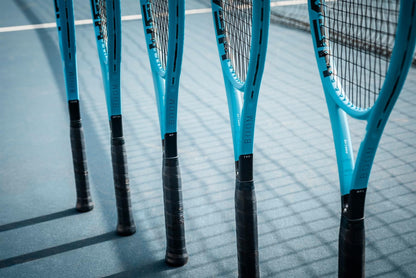 Five HEAD Boom Team 2026 Tennis Rackets with black handles stand upright on a blue tennis court, casting long shadows.