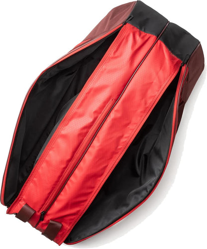 The Yonex 42526EX Team 6 Racket Tennis Bag in Ruby Red is unzipped and open, revealing its red interior lining with black edges. Styled by Yonex, it is empty and laid flat, with zippers and handles visible at the bottom.