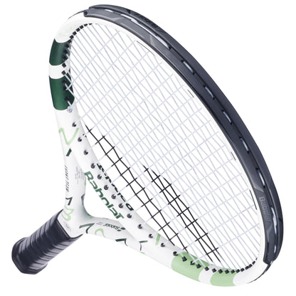 The Babolat Evoke Team Wimbledon 2025 Tennis Racket in White/Champagne Green, featuring a black grip, is photographed on a white background and viewed from an angled overhead perspective.