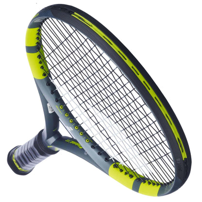 A close-up of the Babolat Pure Aero 2026 Tennis Racket shows its black and neon yellow frame, tightly strung strings, and a black grip handle, set against a white background.
