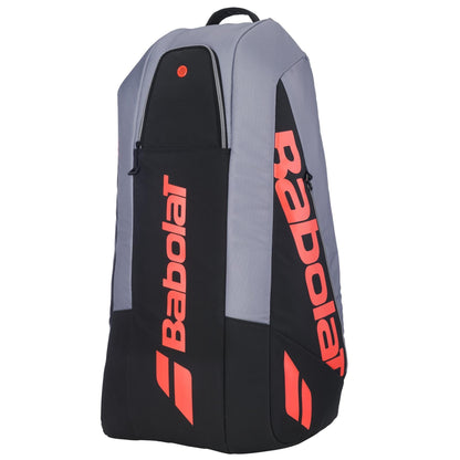The Babolat RH6 Pure Strike 6 Racket Tennis Racket Bag in Carbon Grey offers multiple zippered compartments, a sturdy top handle, waterproof material, and bold red accents to protect and carry your gear in style.