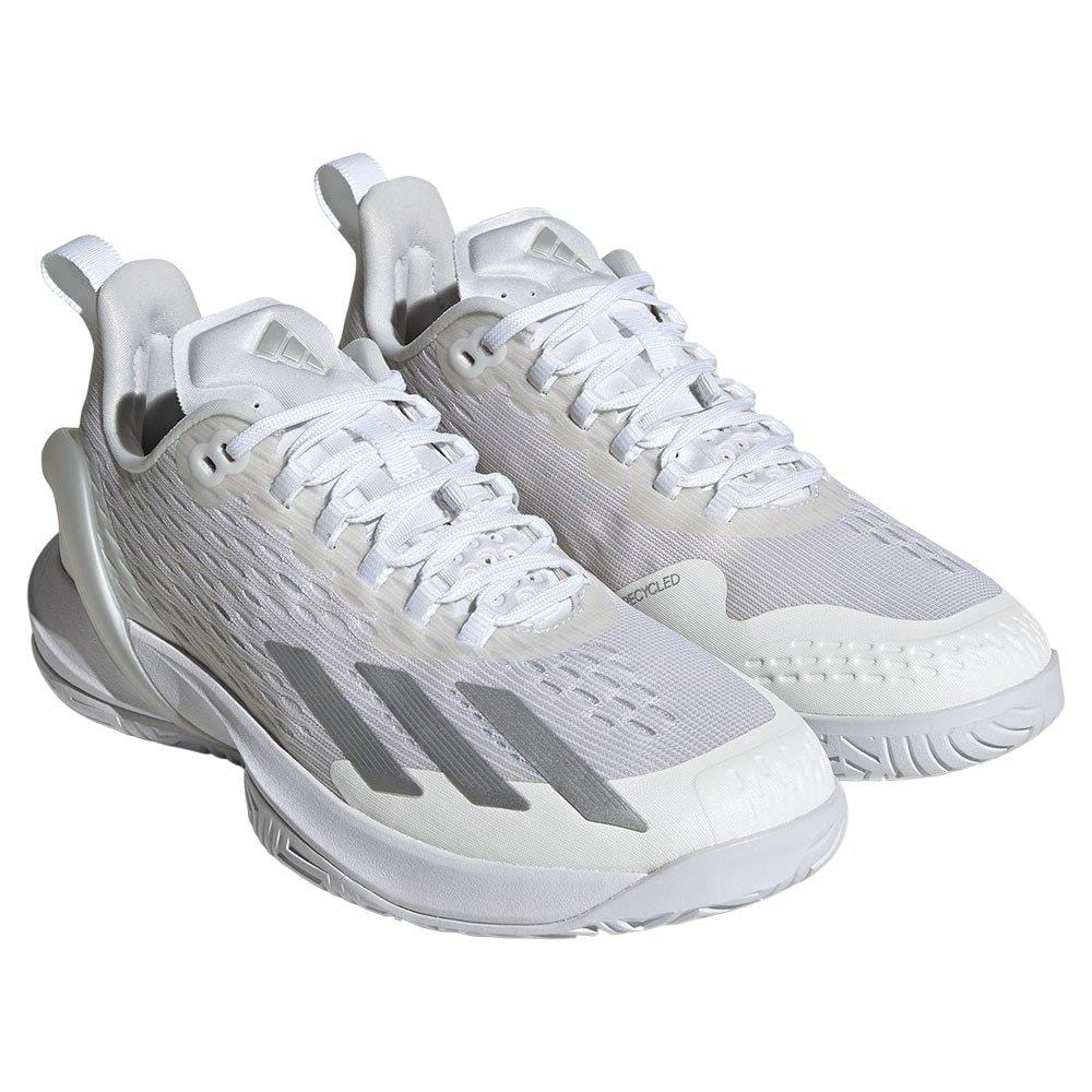 Presenting the adidas Adizero Cybersonic Women's Tennis Shoes in White and Silver, these athletic shoes boast a sleek profile with a textured design. They feature lace-up closures and are engineered to enhance accelerated movement on the court, thanks to their patterned sole that ensures optimal traction.