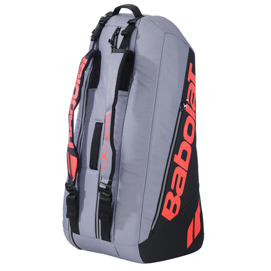 The Babolat RH6 Pure Strike 6 Racket Tennis Racket Bag in Carbon Grey holds up to 6 rackets, features multiple compartments, padded straps for easy carrying, and a waterproof design to protect your gear on the go.