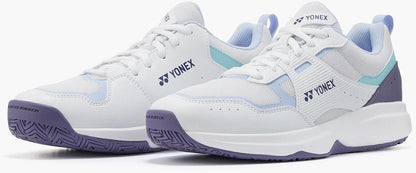 The Yonex Pro-Move Classic Mens Tennis Shoes in White/Sax feature mesh panels, light blue and purple accents, Power Cushion technology, and thick rubber soles—displayed side by side on a white background.