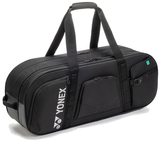 The Yonex BA72631WEX Gearlogic Tournament Tennis Bag in black features two zippered compartments, a side pocket, dual carrying handles, and a shoulder strap with the Yonex logo in white—ideal for carrying your tennis gear.