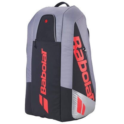 The Babolat RH9 Pure Strike 9 Racket Tennis Racket Bag in Carbon Grey features bold red branding, a top handle, multiple zippered compartments, and a water-repellent design—ideal for carrying your tennis gear in style.