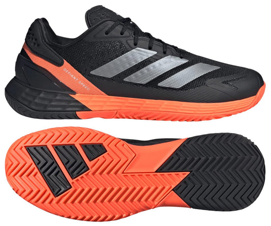 The adidas Defiant Speed 2 Men's Tennis Shoes in black and orange feature silver stripes, orange accents, and a textured orange sole. Side and bottom views showcase their lightweight build, sleek design, and advanced grip pattern.