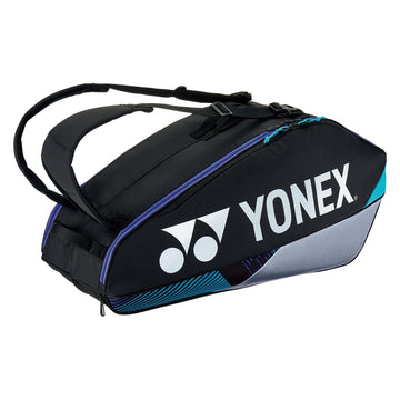 The Yonex 92426EX 6 Racket Pro Tennis Bag in Black/Silver features a sleek design with the signature Yonex logo, adjustable shoulder straps, and subtle blue accents. It offers a spacious compartment for sports equipment, along with a dedicated shoe compartment, making it perfect for tennis enthusiasts on the move.