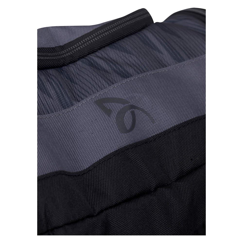 A close-up of the HEAD Djokovic Monstercombi 12R Tennis Racket Bag reveals its dual fabric textures: a subtly patterned anthracite upper section and a sleek black lower section. The center prominently features a logo resembling a stylized number 6 or letter G, showcasing the CCT+ climate control technology inspired by Novak Djokovic's equipment.