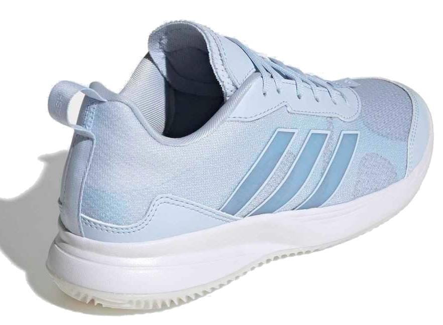 The adidas AvaFlash Women’s Tennis Shoes - Blue feature a light blue design with white sole, signature three stripes, and a heel loop. Displayed at an angle from the back and side on a white background.