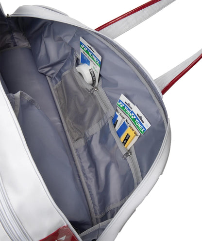 Open Yonex 02631WEX Expert Tournament Tennis Bag - White, featuring red handles and two mesh zippered pockets inside. Each pocket holds Yonex badminton grip tape. Includes a dedicated shoe compartment for added convenience.