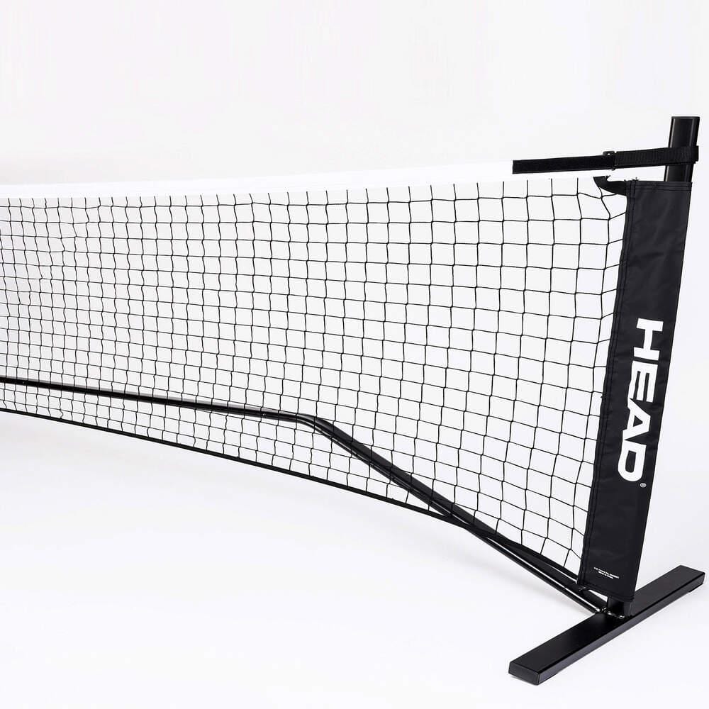 The HEAD 10 and Under Mini Tennis Net - 6.1m is a portable black and white tennis net featuring the "HEAD" logo. Designed for indoor use, it boasts a sleek and sturdy frame, making it ideal for Kids Tennis or 10 and Under Tennis practice and recreational play.
